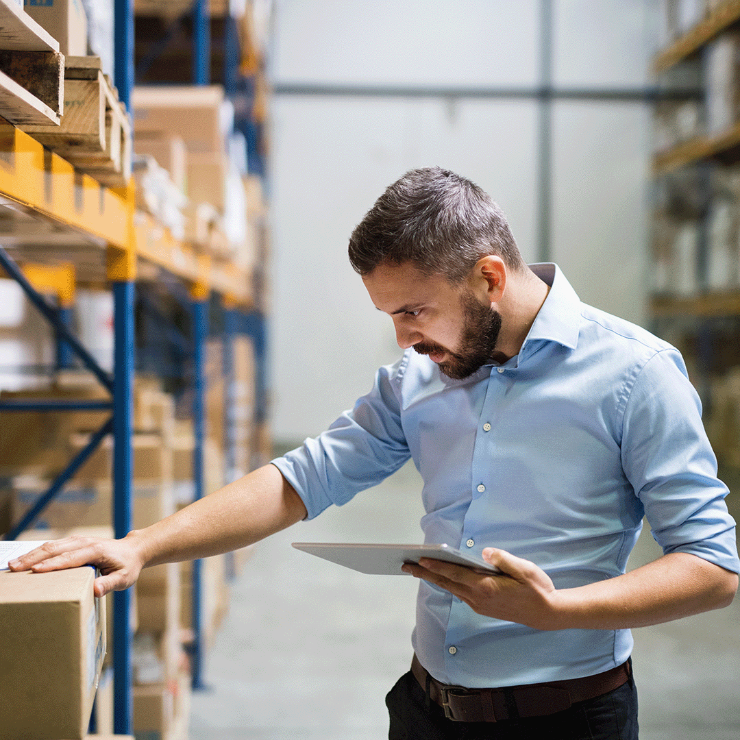 Man in Wholesale Warehouse using a Tablet