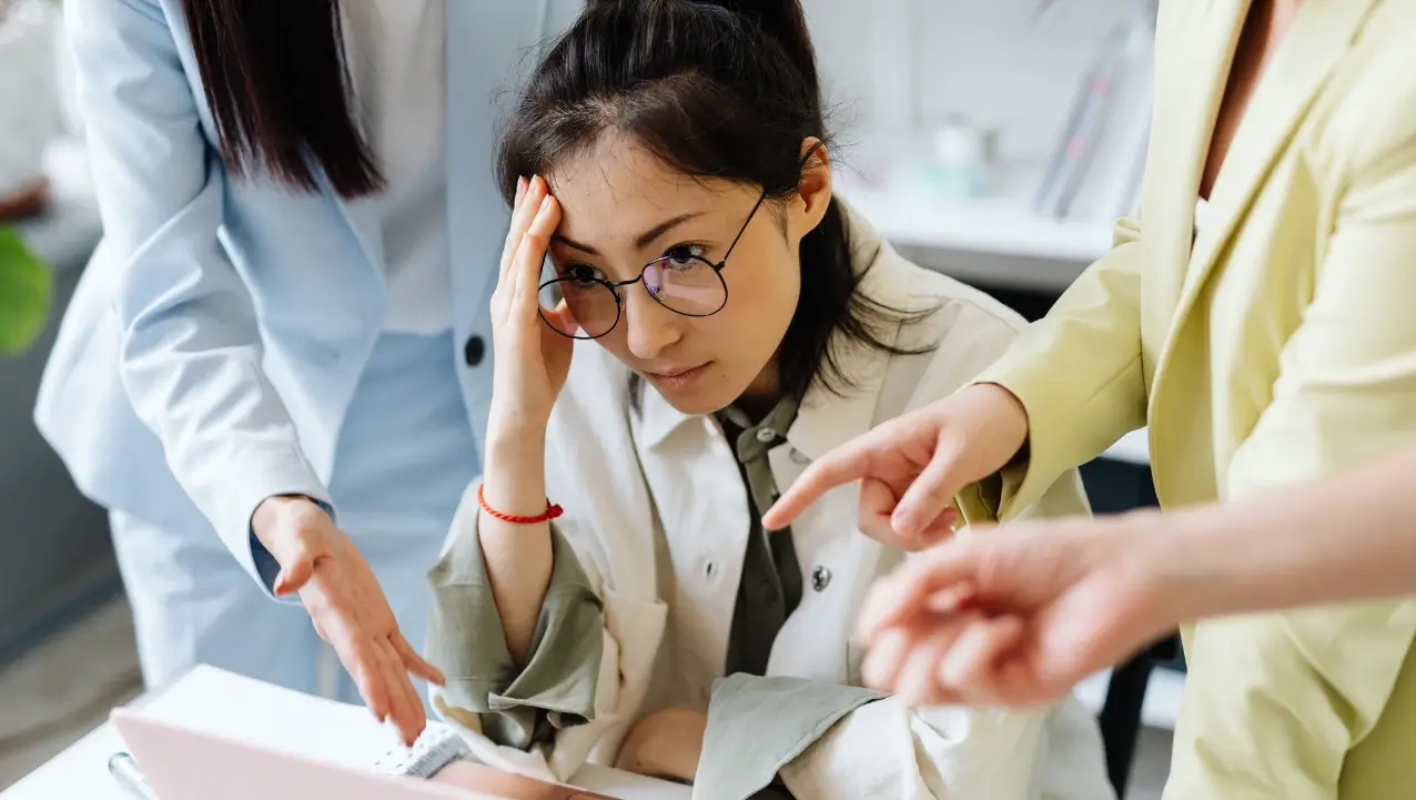 Overwhelmed Female Office Worker Stressed woman overwhelmed with work at her desk